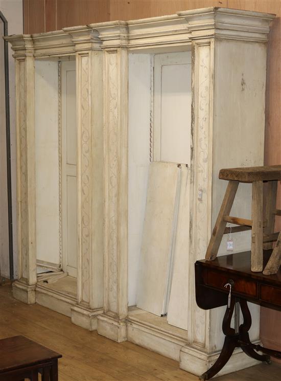 A pair of large white painted open library bookcases W.119cm